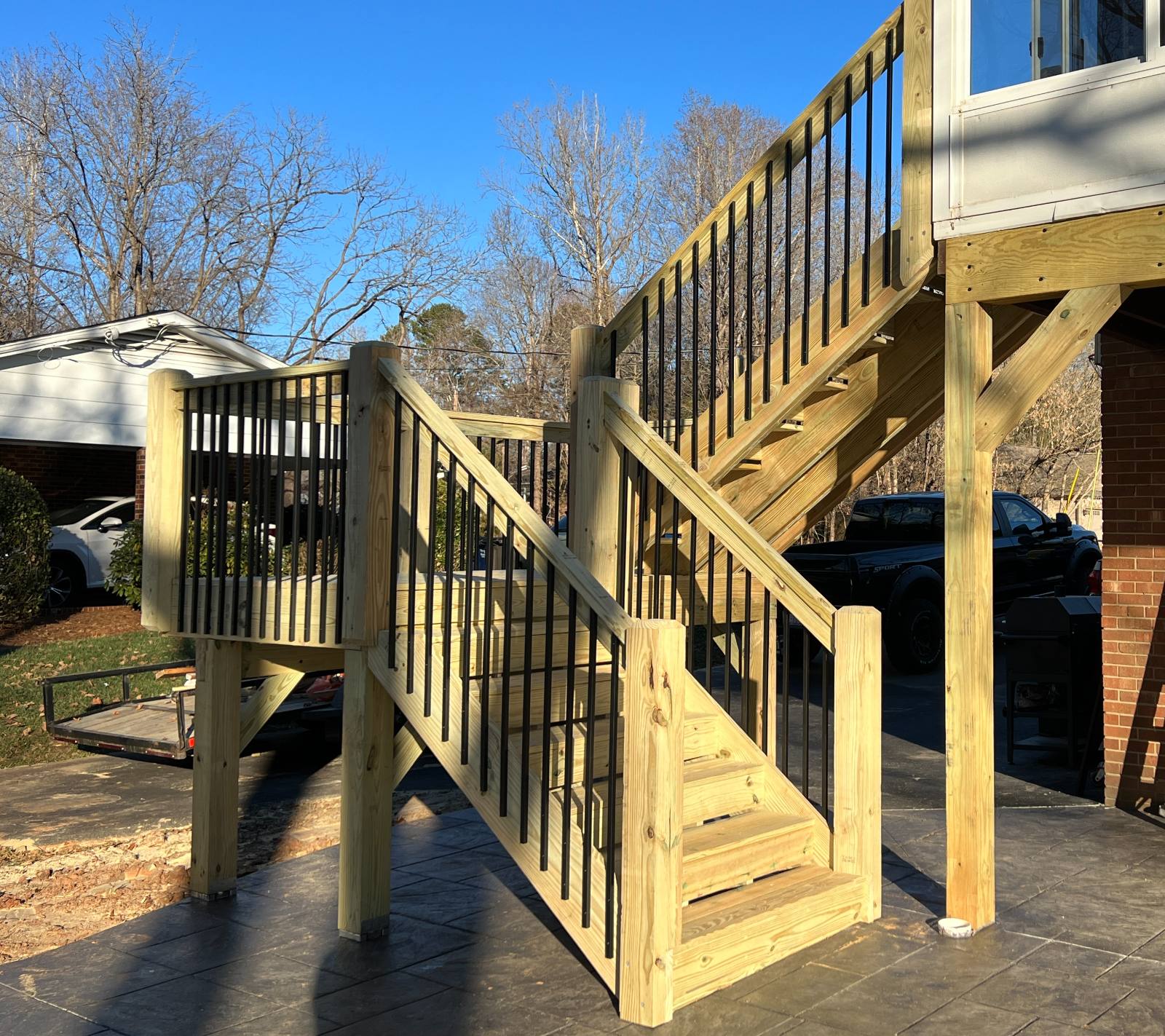 Sturdy Custom Pressure-Treated wood Stairs & Black Railing